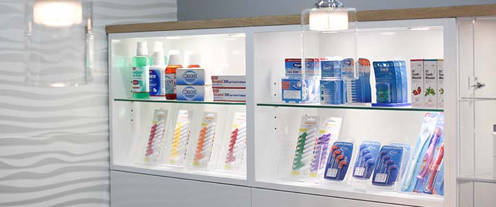 different types of toothpaste, toothbrushes and dental flosses displayed at Harwood Dental Care 
