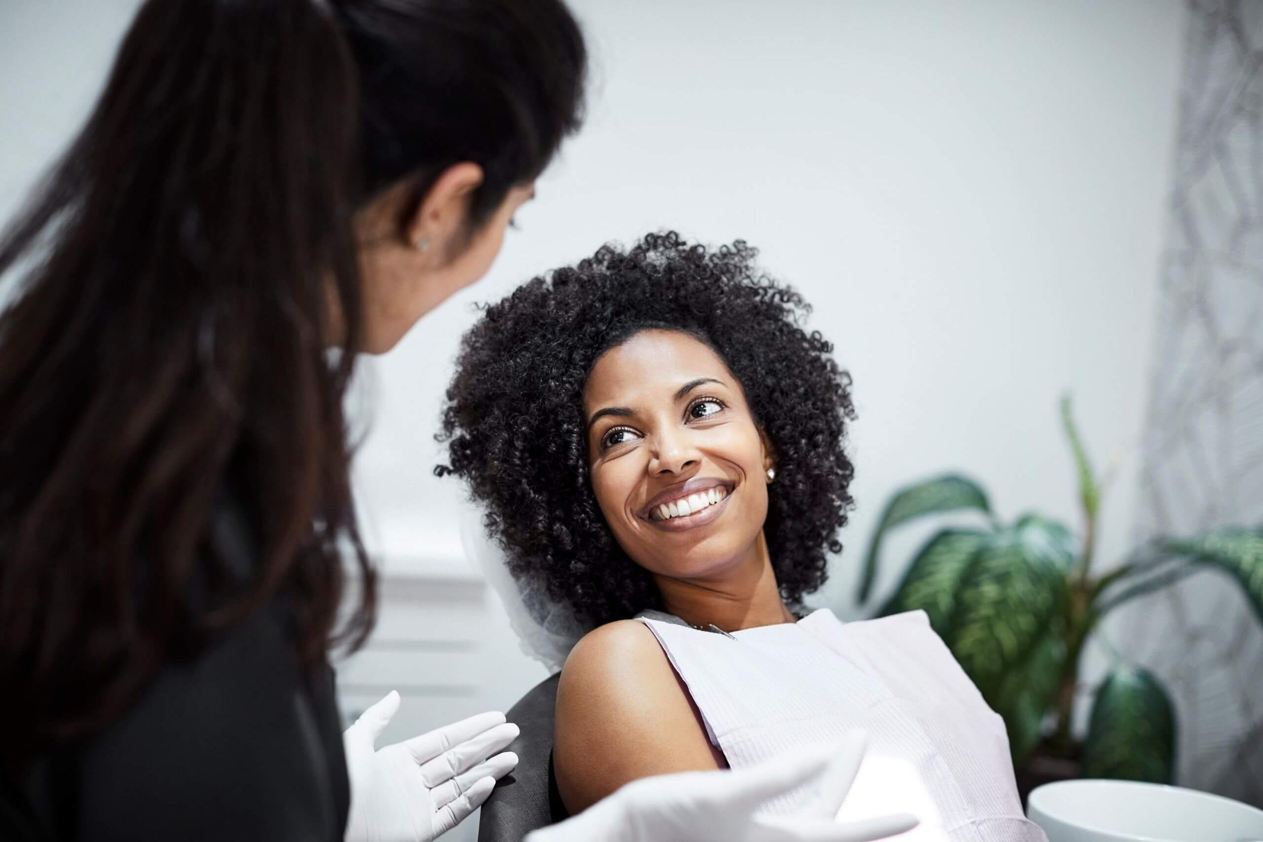 A woman sitting at the dentist smiling