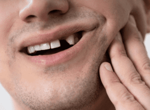 Man with loose tooth at Harwood dental practice