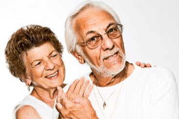A mature couple smiling with dental implants in Bolton