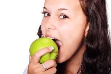 A woman eating an apple in Bolton