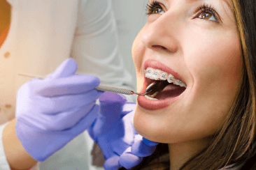 Women getting her adult braces checked