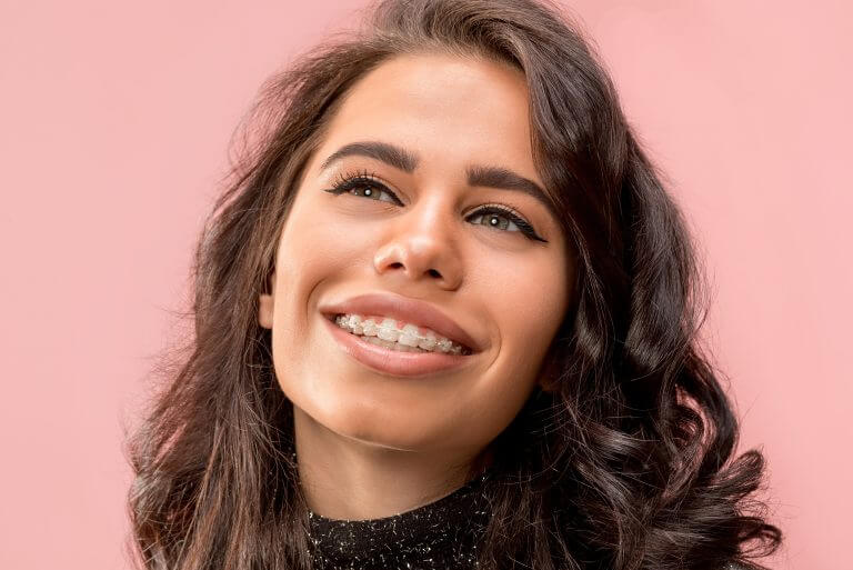 Brunette female smiling with braces