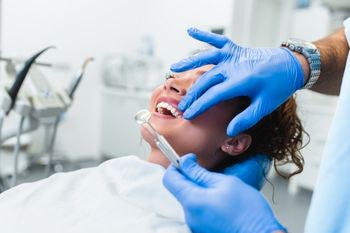 Woman having her dental implants fitted at Harwood Dental