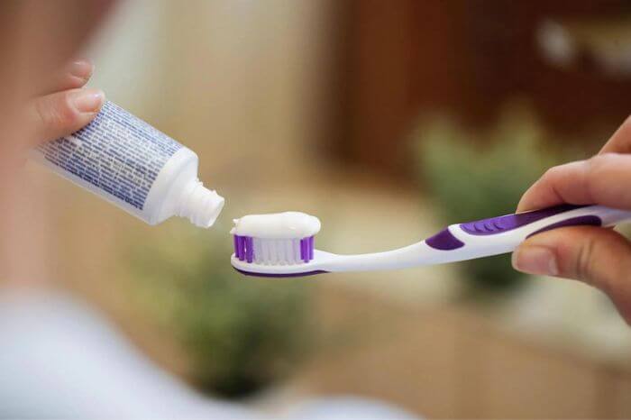 Toothbrush getting toothpaste on it