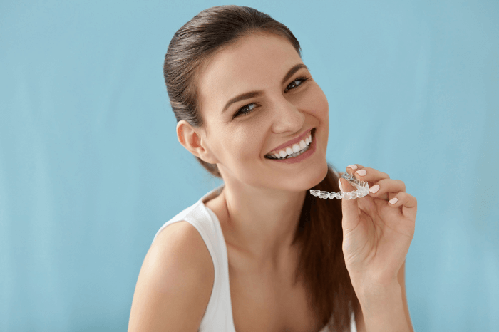 Woman Holding Invisalign at Harwood Dental Care - Harwood, Bolton