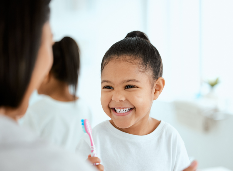 A small child smiling and enjoying her Dental check up appointment at Harwood Dental Care