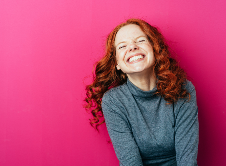 woman smiling with straight teeth after Invisalign treatment