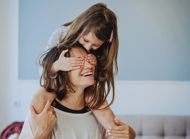 child sat on mothers shoulders after talking about braces options