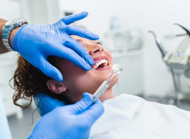 woman receiving a standard check up at harwood dental care