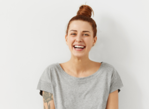 woman smiling after Invisalign treatment at harwood dental practice