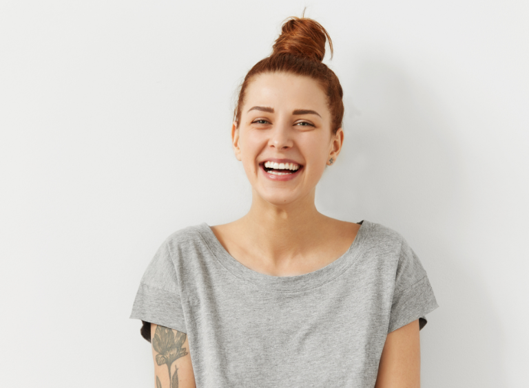 woman smiling after Invisalign treatment at harwood dental practice